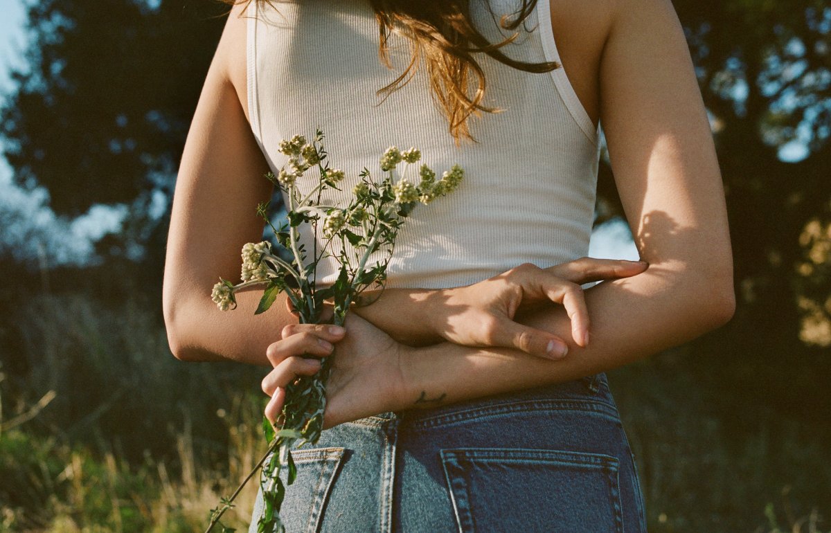 Girl holding flowers behind her back