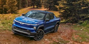 Chevy Silverado electric vehicle driving up a dirt trail