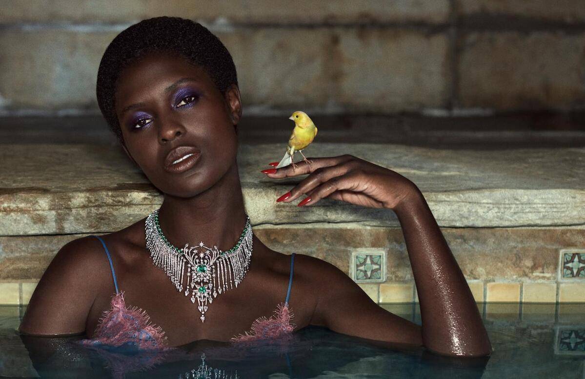 Model poses in a pool wearing Gucci's new Hortus Deliciarum collection