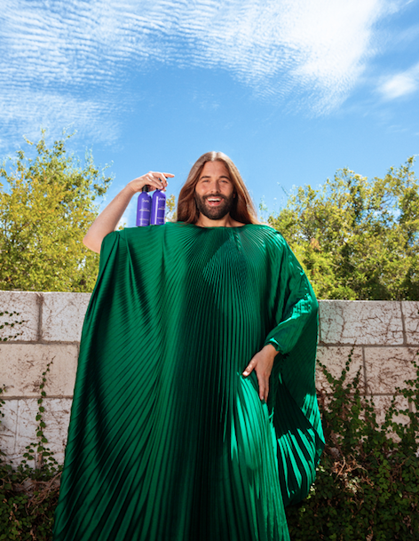 Jonathan Van Ness (JVN) poses with a product from their hair and beauty line, JVN Hair.